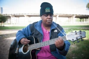 Homeless woman with guitar 700p